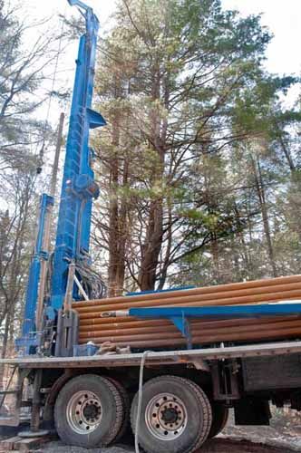 A water well drill is set up on a truck